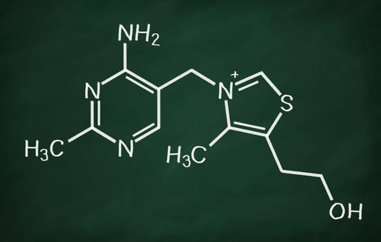 Structural model of Vitamin B1 (Thiamine) on the blackboard.