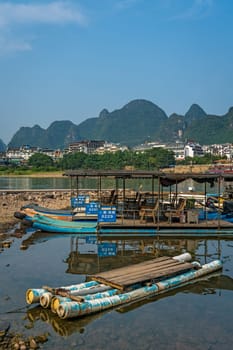 Yangshuo, China - August 2019 : Small tourist and fishermen boats on the Li river shore, the ferry crossing point in Yangshuo