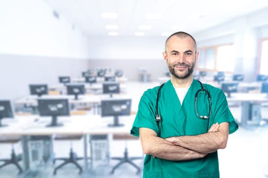 portraits of a smiling doctor wearing green uniform, arms crossed and computer room in the background.