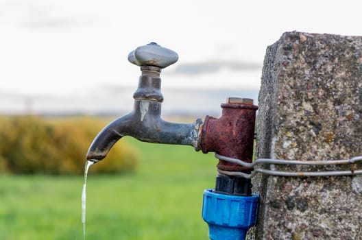 A old rusty water tap in garden