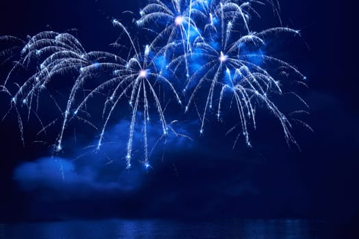 Blue colorful fireworks on the black sky background