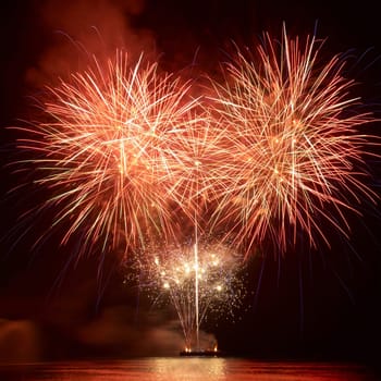 Colorful red fireworks on the black sky background