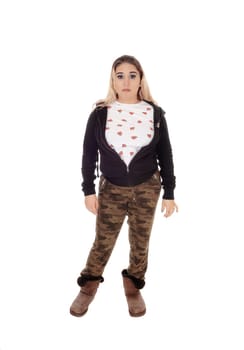 A young beautiful woman standing in camouflage pants and a black.sweater and boots isolated for white background.