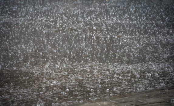 Heavy falling and splashing monsoon rain on the street background detail overlay