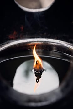 Fire burning in the memorial candle in the Wenshu Monastery, Chengdu, China