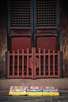 Three colorful praying kneeling pads in the courtyard of the Buddhist Wenshu Monastery, Chengdu, Sichuan Province, China