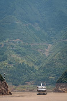 Luxury passenger cruise ship sailing through the gorge on the magnificent Yangtze River, China