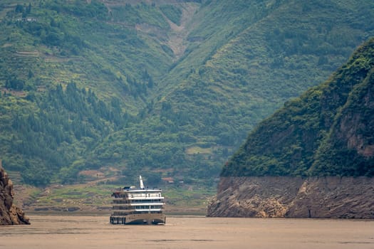 Luxury passenger cruise ship sailing through the gorge on the magnificent Yangtze River, China