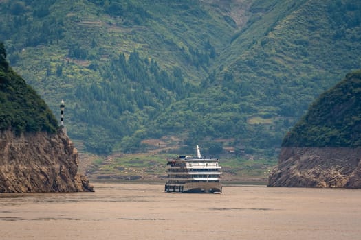 Luxury passenger cruise ship sailing through the gorge on the magnificent Yangtze River, China