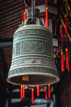 Large Brass Bell hanging under the roof in Wenshu Monastery, Chengdu, China