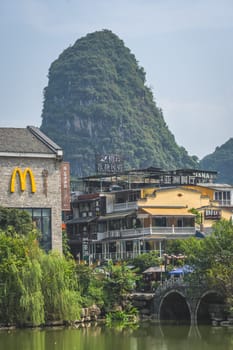 Yangshuo, China - August 2019 : Macdonald restaurant logo in Yangshuo Old Town tourist centre, Guangxi Province