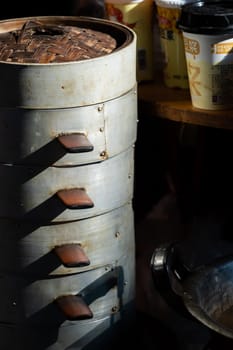 Feng Huang, China - August 2019 : Cooking untensils and containers used to prepare telicious traditional chinese Baozi buns, steamed buns filled with ground pork meat and cabbage prepared on hot steam, steamed