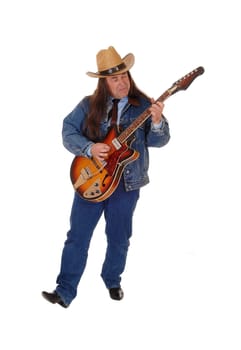 A handsome indigenous man in a jeans jacket, pants and a cowboy hat.standing and playing the guitar, isolated for white background.