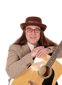 A middle age man sitting in a brown jacket and hat, wearing glasses.and holding his beloved guitar, isolated for white background.