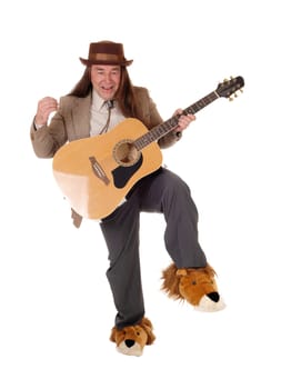 A middle age indigenous man in fancy shoes dancing and playing.his guitar in a jacket and hat, isolated for white background.