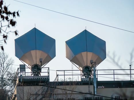 Satellite dish on the roof of the building against the blue sky. Technology. Place for text. Background image.