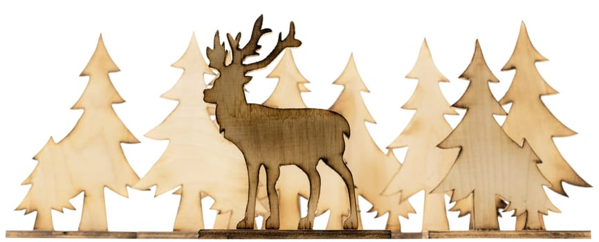 Cut out deer figure made of wood with dark edges and wooden fir trees isolated on white