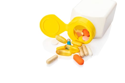 Pills from a drug bottle isolated on white background.