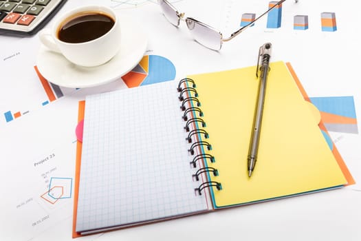 Notepad with a pen, coffee and papers business concept.
