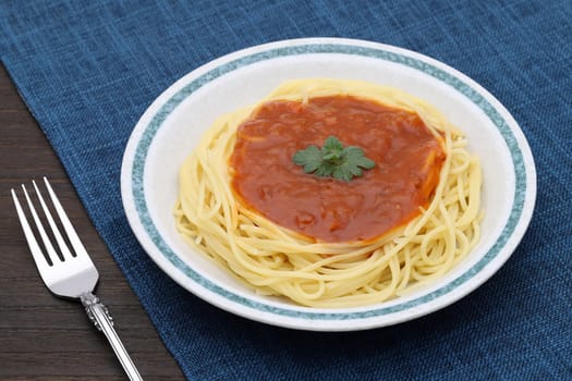 Pasta spaghetti with tomato sauce and basil on white background on dining table