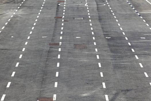 White racetrack lines on pavement street floor