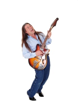 A happy musician playing his guitar with his long brunette.hair, singing, isolated for white background.