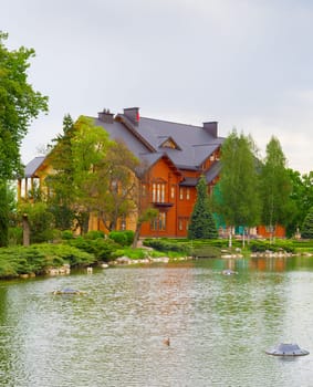 Large wooden house and pond in front. Mezhyhirya, Kiev, Ukraine