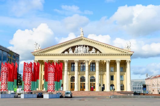 Labour Union Palace of Culture, waving national flags at central October Square, Minsk, Belarus