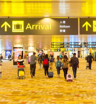SINGAPORE - JANUARY 13, 2017: People at Changi International Airport terminal in Singapore. Changi - largest airport in the world.