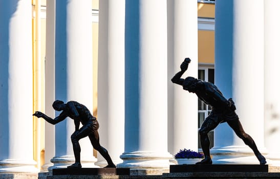 Two statues depicting ancient people with columns in background, Russia, Saint Petersburg