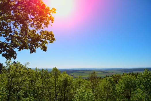 Green landscape from above, with sun in the Rhön, Germany, with copy space