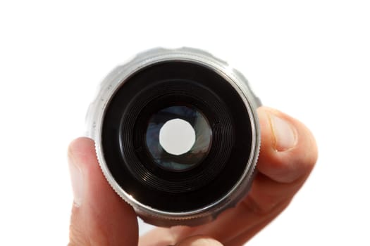Hand holding retro camera lens on white background
