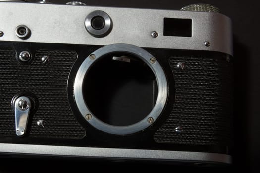 Retro film photo camera on black background