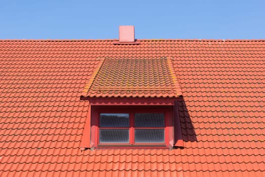 red tile roof with window and chimney