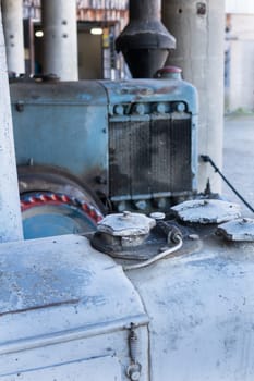 Close up of the motor area of two old farm tractors