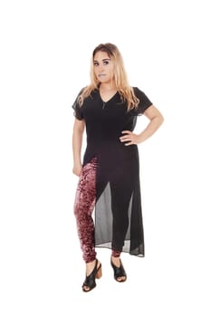 A lovely young woman standing from the front in a black dress with . colorful tights under, isolated for white background.