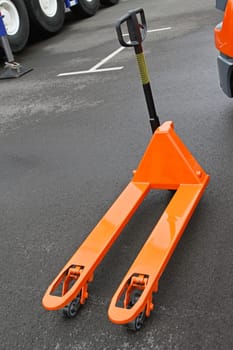 Orange manual pallet jack  truck for transport