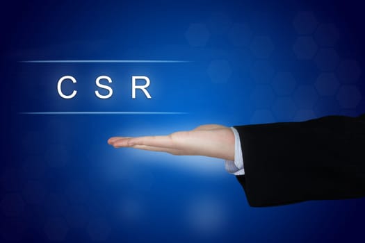 CSR or Corporate social responsibility button with business hand on blue background