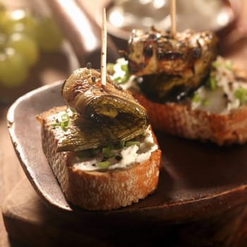 Close up Gourmet Tasty Creamed Bread with Grilled Fish Meat on Wooden Serving Ladle at the Table.