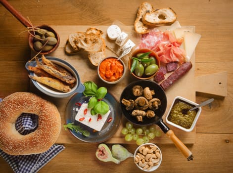 High Angle View of Various Tasty Tapas on Wooden Board on Top of Wooden Table