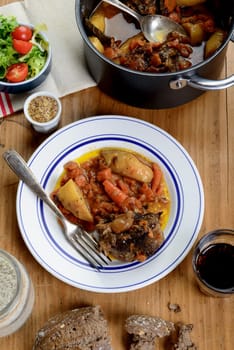 beef dish with carrots on the old table