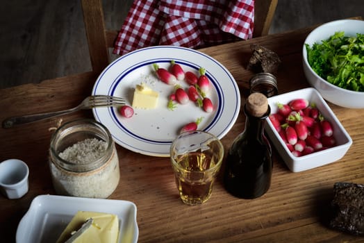 plate with radish , butter and cider on a rustic table