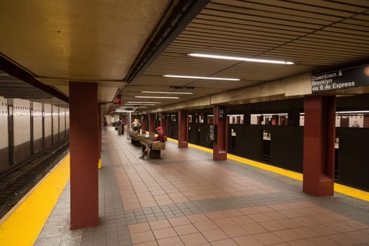 New York - July 9: New York residents wait for the train at the 34th Street Subway Station platform on July 9, 2014 in New York, USA