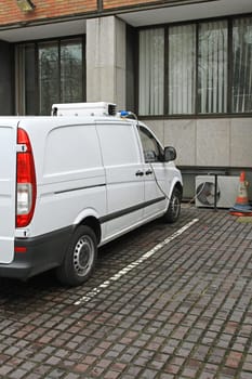 Electric refrigeration van charging on parking spot