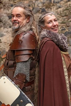 Couple posing robed in beautiful medieval clothing
