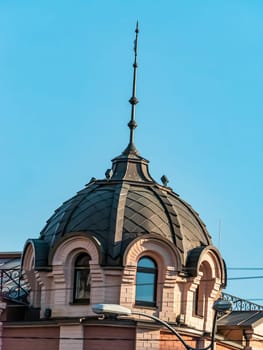 Peak on the roof of the building against the blue sky. Architecture. Place for text. Background image.