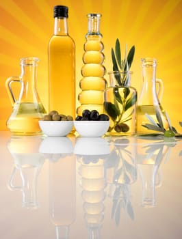 Bottles with organic cooking olive oil and olive branch