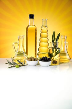 Bottles with organic cooking olive oil and olive branch