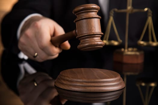 Judge, male judge in a courtroom striking the gavel
