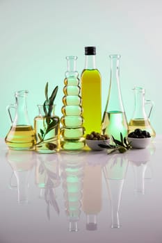 Bottles with organic cooking olive oil and olive branch